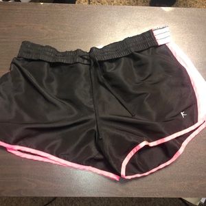 Mainly black comfy shorts with some white and pink